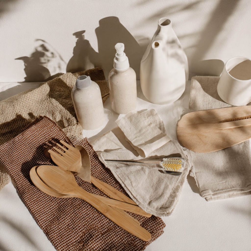 Eco-friendly home and lifestyle products arranged on a neutral background with natural textures.