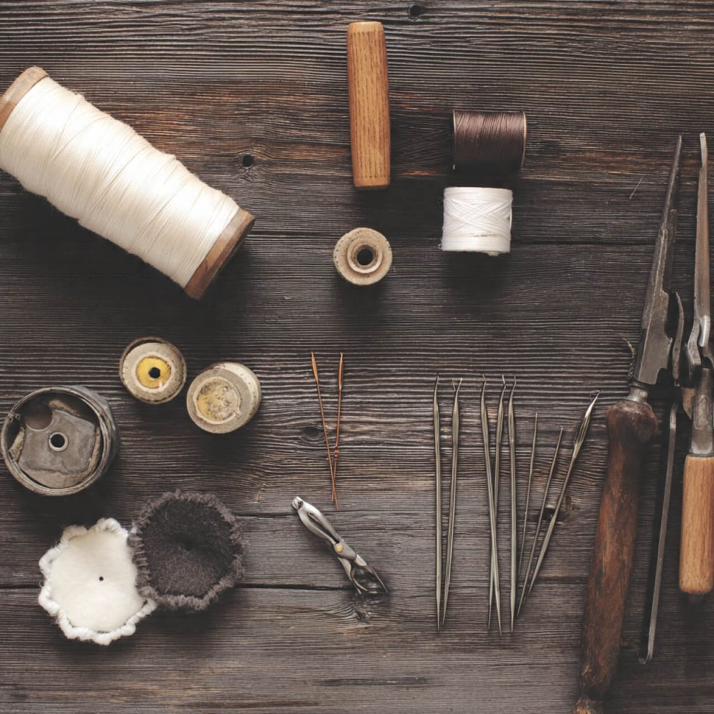 Flatlay of repair tools and sewing materials symbolising repair and reuse services