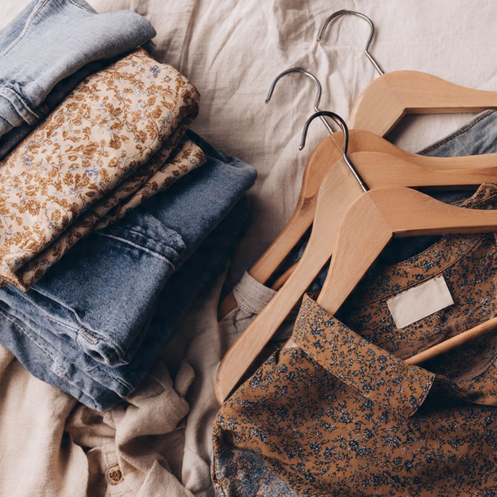 Flatlay of vintage clothing textures and retro fabric patterns on a neutral background